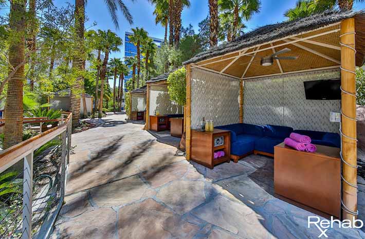 A look inside the upper level main pool cabanas featuring a safe, TV, and refrigerator.