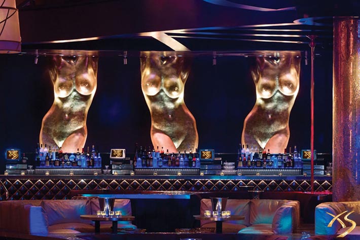 Statues of women's bodies are featured behind the bar at XS Las Vegas