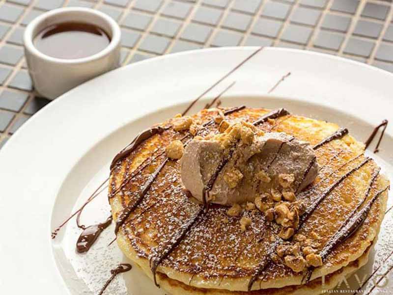 Pancakes topped with whipped Nutella butter and a hazelnut crunch.