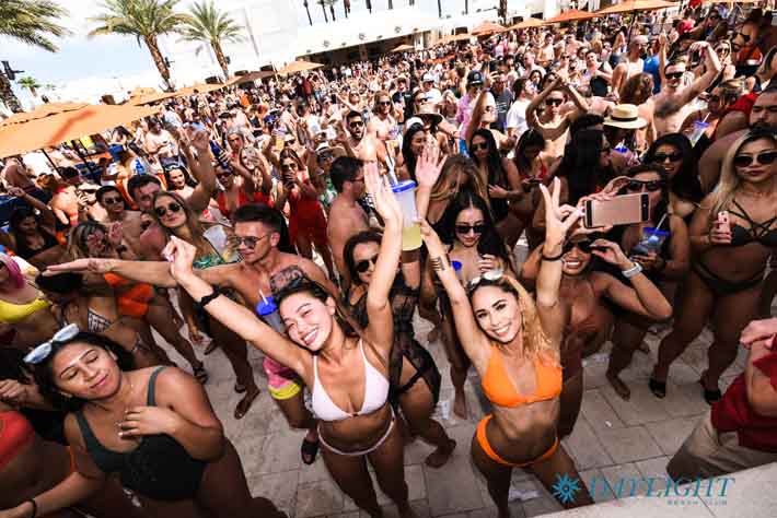 um grupo de mulheres celebrando na piscina da luz do dia.