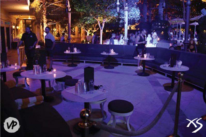 A photo of the outside patio tables near the DJ booth at XS