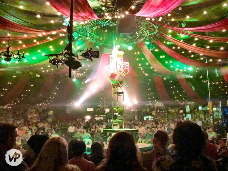 A performer builds a chair tower at the Absinthe show in Vegas