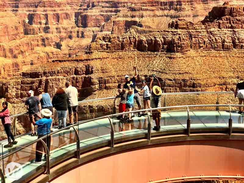 A photographer taking pictures of visitors on the Skywalk