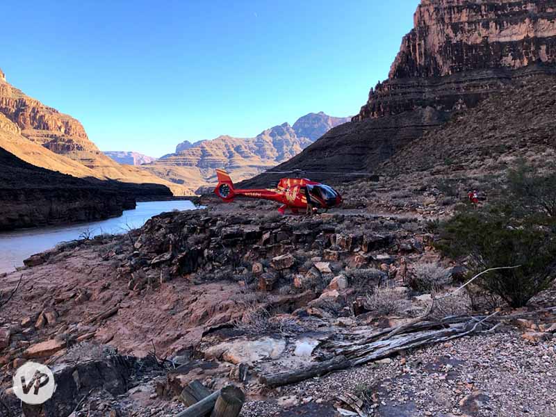 A helicopter lands at the bottom of the Grand Canyon