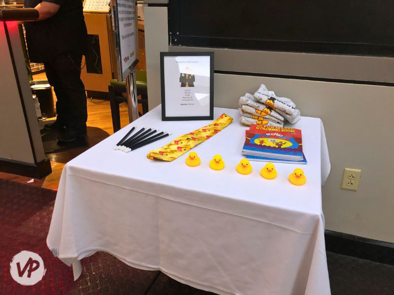 Photo of a duck, coloring book, tie, and other show souvenirs