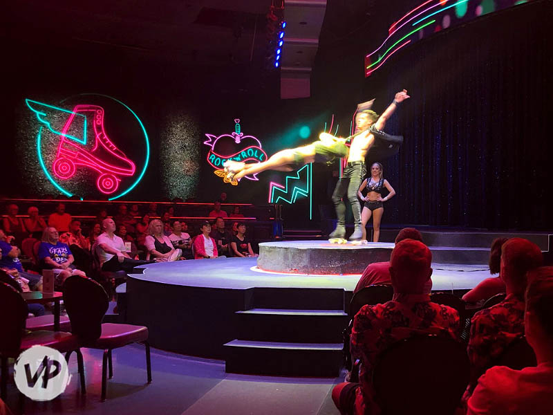 A man on roller skates spins a woman in the air
