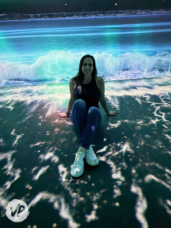 My friend sitting in the ocean waves at the museum